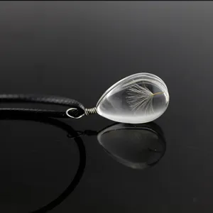 Glass dandelion seed teardrop pendant necklace with black cord, elegant handmade jewelry gift.