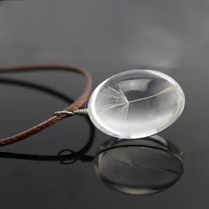 Dandelion seed clear glass oval pendant necklace detail close-up showing natural plant botanical art.