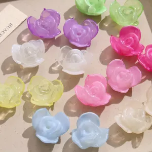 Close-up detail of translucent acrylic rose flower charms for DIY jewelry making and crafts.