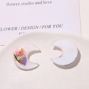 Resin dried flower crescent moon DIY accessory for phone cases, hair clips and earrings.