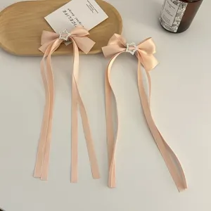 Pink satin ribbon bow hair clip with rhinestone star charm and secure duckbill clip for sweet look.