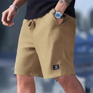 Shorts décontractés en tricot gaufré pour hommes, ample de sport avec cordon.