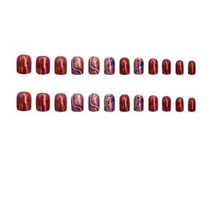 Set di unghie finte rotonde medio-lunghe chic con glitter rossi eleganti e motivi di stelle.