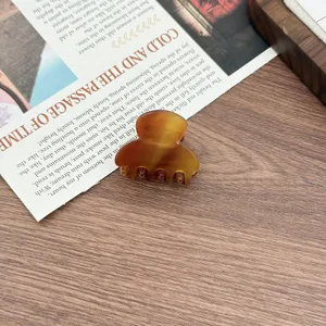 Mini acetate hair claw clip for women, stylish tortoiseshell mini hair claw for daily use.