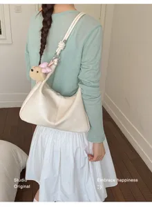 Casual minimalist hobo shoulder bag with cute bear pendant, stylish PU leather commuting handbag.