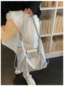 Korean style silver metallic hobo shoulder bag with front zipper pockets and flap closure.