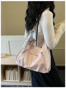Stylish pink shoulder bag for women, featuring multi-zipper pockets and chic daily design.