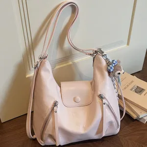 Pink PU leather shoulder bag for women, stylish tote with zipper pockets and cute plush charm.