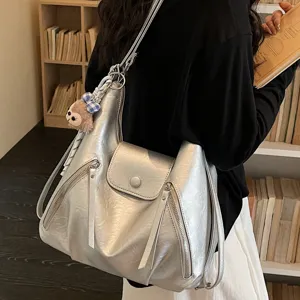 Stylish silver shoulder bag for women, trendy multi-pocket casual tote and daypack.