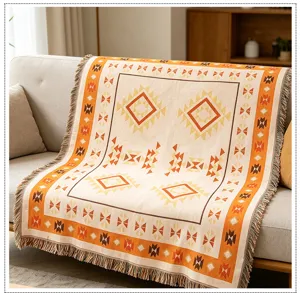 Boho knitted throw blanket detail showing intricate geometric patterns and tassel fringe.