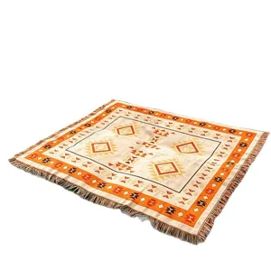 Bohemian ethnic knitted jacquard throw blanket for sofa decor and camping, angled view.