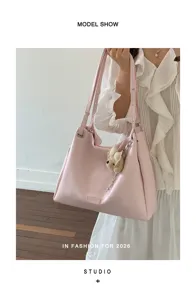Pink PU leather tote shoulder bag with cute furry charm, stylish vintage commuting style detail.