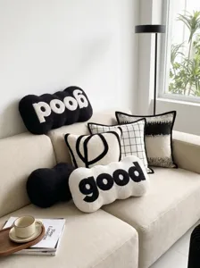 Modern minimalist black and white decorative throw pillow set detail, unique letter design for cozy sofa.