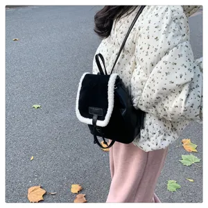 Detail shot of black faux shearling backpack, vintage style, versatile autumn winter bag.