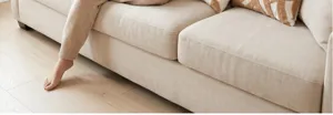 Cream tufted abstract pattern throw pillow detail in a cozy home living room setting.