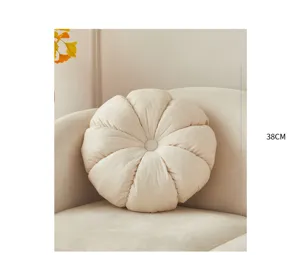 Cozy beige pleated round plush pillow for sofa and living room decor, soft wheel cushion.