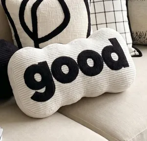 Close-up detail of the modern cream white long letter decorative pillow with black texture.