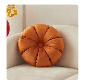 Orange velvet round pleated throw pillow, cozy wheel cushion for sofa and living room decor.