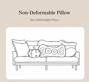 Detail view of decorative irregular throw pillows on sofa with letter and pumpkin designs.