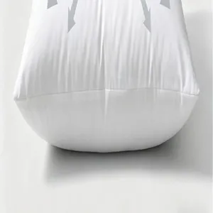 White throw pillow with grey geometric arrow pattern, soft fabric cushion for home decor.