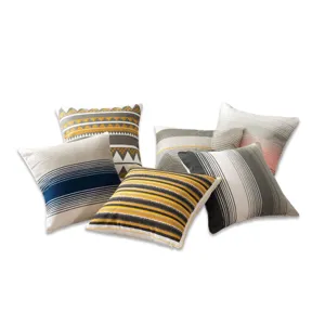 Detail view of Nordic boho throw pillow collection featuring geometric embroidered patterns and stripes.