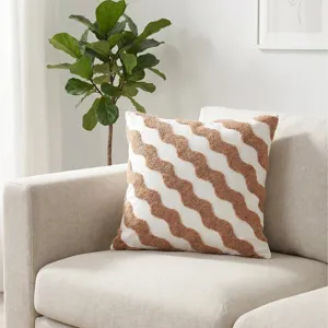 Boho tufted throw pillow with brown wavy stripes on white fabric for modern living room sofa.