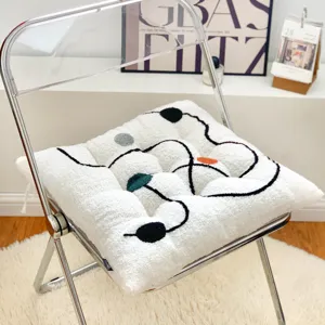 Plush seat cushion with colorful polka dots and abstract lines for office chair winter use.