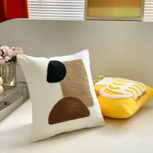 Detail view of cream style geometric embroidered throw pillow, perfect for modern sofa and bed decor.