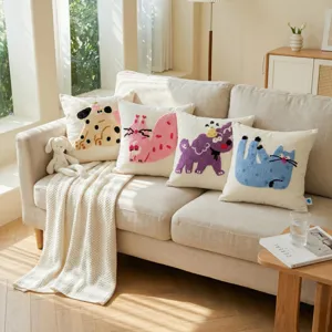 Detail view of cozy living room tufted animal embroidery throw pillows on beige sofa with blanket.
