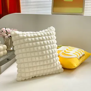 White textured square throw pillow detail, plush grid cushion for modern home decor.
