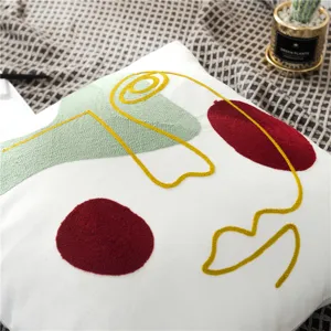 Modern abstract face embroidered throw pillow detail, stylish cushion cover for home decor.