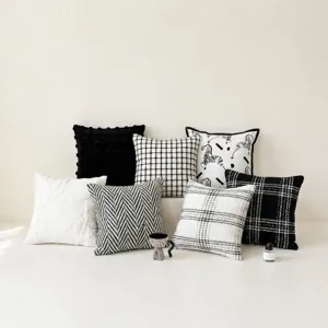 Black and white decorative throw pillows, modern geometric grid and zebra pattern cushions.