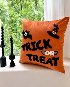 Halloween pumpkin orange throw pillow with cute embroidery bat witch hat details, soft fabric.