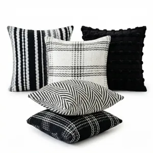Black and white textured throw pillow set, detail view of various modern sofa cushions.