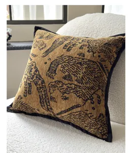 Vintage designer artistic throw pillow detail, textured woven fabric with black piping.