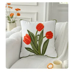 Detail shot of Nordic embroidered tulip throw pillow cover on cozy sofa with cozy floral decor.