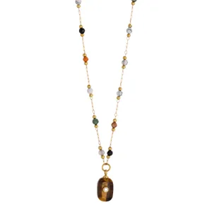 Detailed view of the beaded chain necklace with natural stone pendant and sparkling crystal accent.