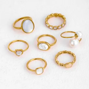 Set of 7 minimalist stainless steel gold rings featuring natural stone, mother of pearl & pearls.