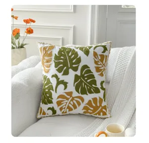 Nordic style embroidered throw pillow with green and gold monstera leaves for sofa living room