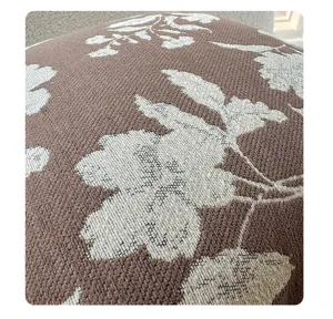 Close-up of vintage French style textured pillow cover with woven floral leaf pattern.