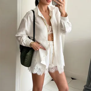 Detail view of women white long sleeve shirt and lace shorts summer casual fashion set.