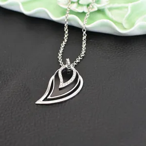 Silver layered teardrop pendant sweater chain with sparkling rhinestones and black inlay.