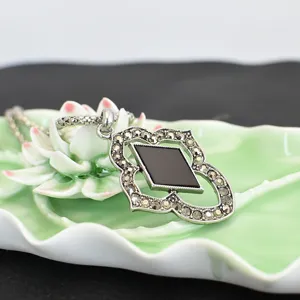 Vintage Thai silver necklace pendant close-up, black stone and rhinestone inlay detail.