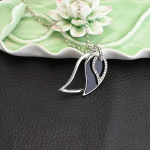 Silver rhinestone black enamel leaf pendant necklace stylish metal chain jewelry accessory.