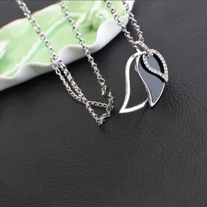 Silver-tone split teardrop pendant necklace with rhinestones on a chunky chain detail shot.