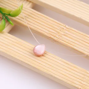 Delicate pink teardrop shell pearl necklace on invisible fishing wire for minimalist style.