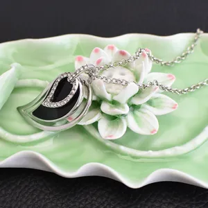 Silver multi-layer leaf pendant necklace with dazzling rhinestones and black inlay details.