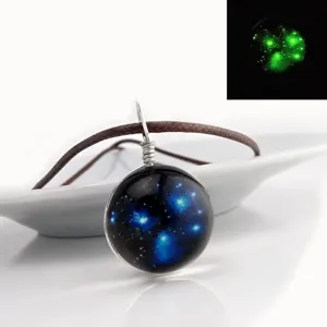 Luminous glass galaxy pendant necklace with brown cord, cosmic universe glowing jewelry gift.