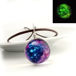Galaxy glass dome pendant necklace with luminous starry sky design and brown leather cord