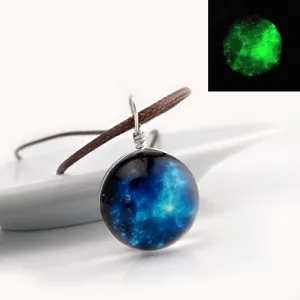 Close-up detail of the glowing galaxy glass cabochon pendant necklace with brown cord.